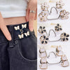 Silver and gold no-sew adjustable buttons used to tighten the waist of dark denim jeans