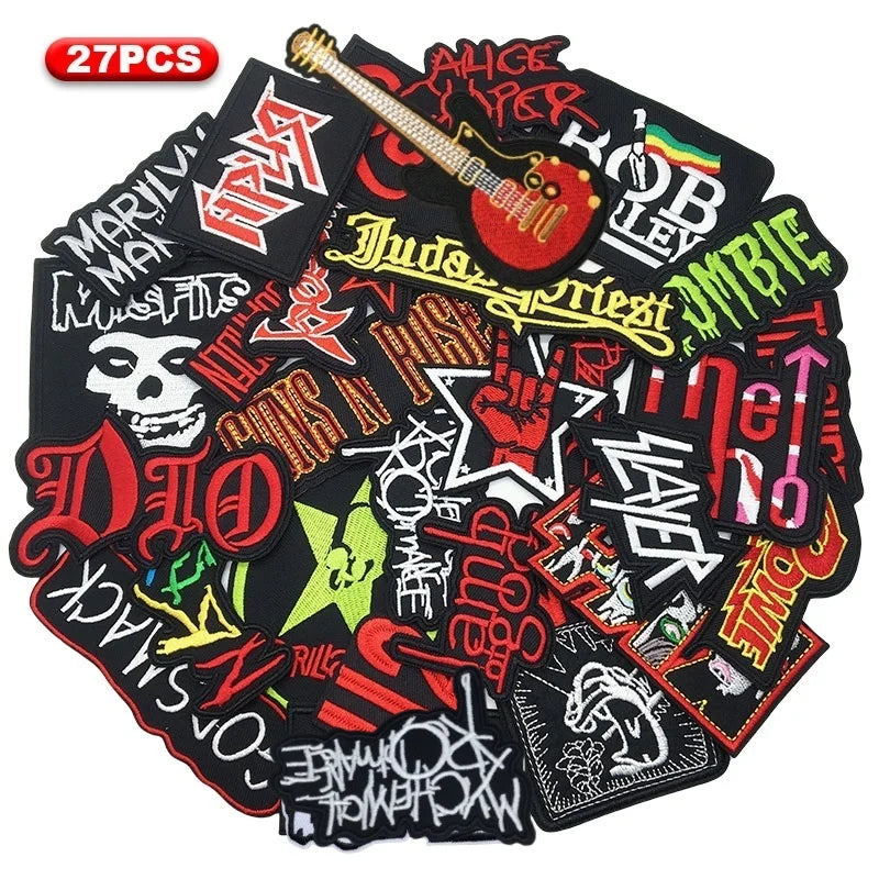 A set of 27 embroidered iron-on patches featuring various rock and metal band logos and symbols on a black background.