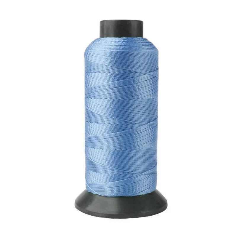 A spool of light blue heavy-duty nylon sewing thread for upholstery and denim.