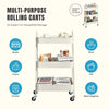 A white multi-purpose rolling cart with three tiers used for household storage like books, fruits, snacks, and wash supplies.