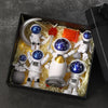 A set of handcrafted astronaut figurine resin spacemen desk decor displayed in a black box.