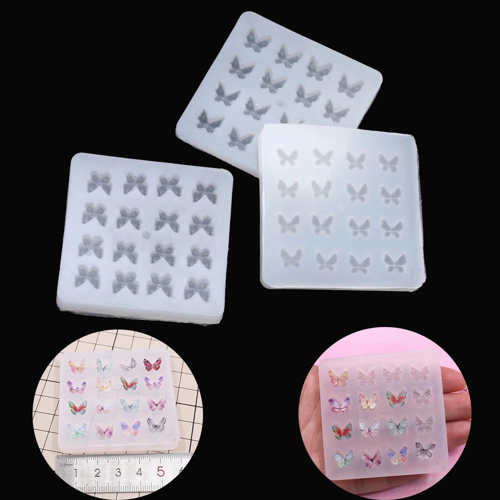 A collection of clear epoxy resin molds shaped like butterflies in various sizes and colors.