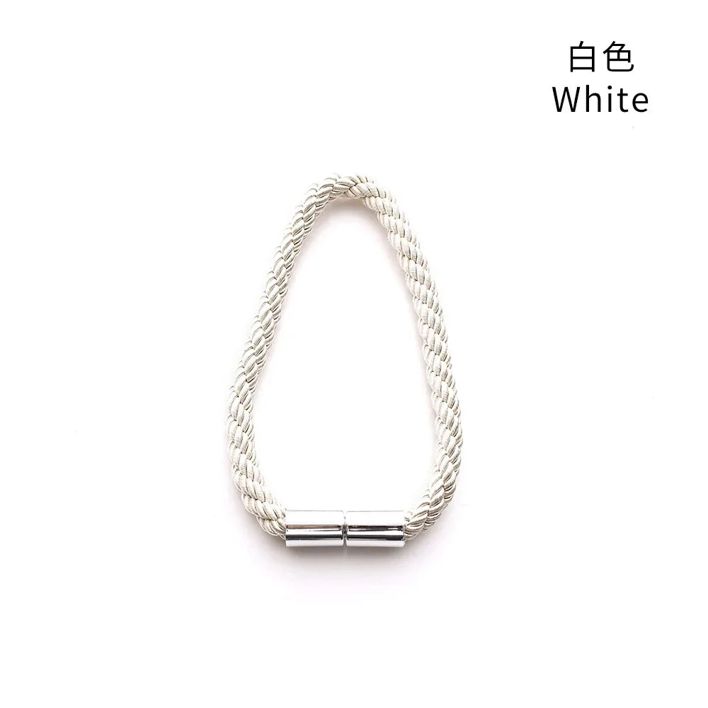 A white magnetic curtain tieback featuring a braided rope and a metal buckle clasp.