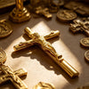 A close-up of a gold crucifix pen set featuring an INRI Jesus cross writing instrument on a brown surface.