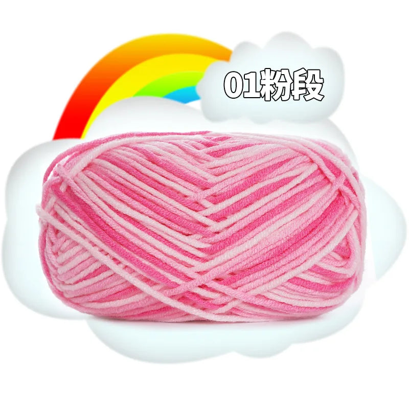 Pink milk cotton blend yarn skein with a rainbow background.