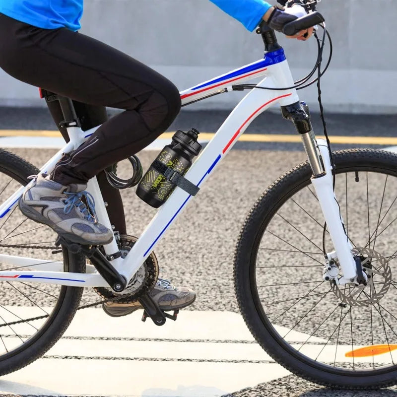 A person riding a white bicycle with black pants and blue shirt, featuring reusable nylon cable ties on the frame.