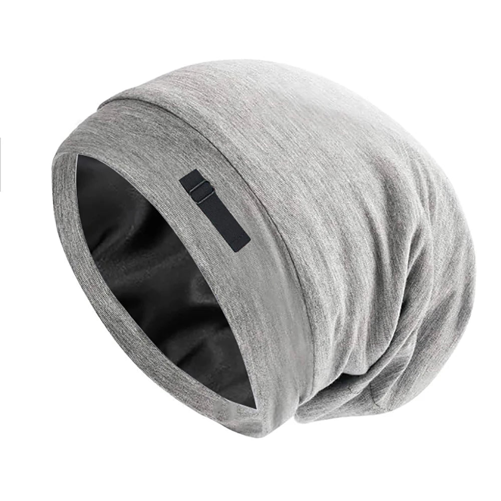 A gray silk-like night cap rolled up, designed for long hair and curls.
