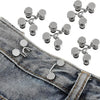 A close-up view of adjustable denim jeans with a set of four silver waist tightening buttons.