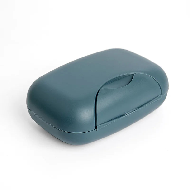 A compact, matte blue leak-proof travel soap box with a hinged lid.