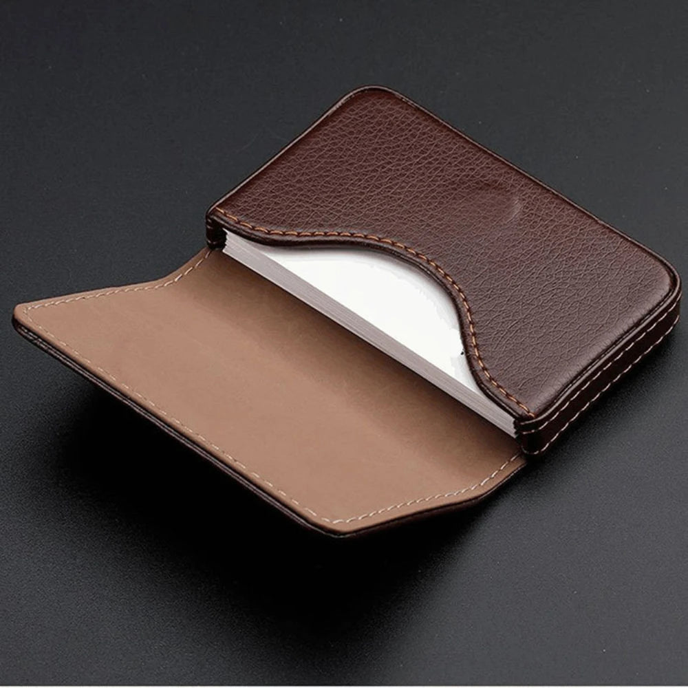 A brown stitched PU leather card holder wallet shown open on a dark surface.