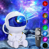 A white astronaut night light projector with a blue visor and a remote control, set against a starry space background.