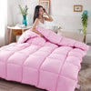 Pink quilted comforter with a cotton cover displayed on a bed.