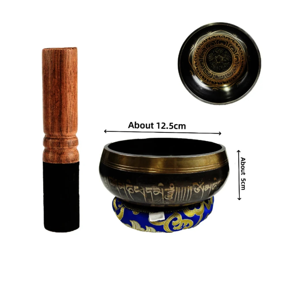 Handcrafted Tibetan singing bowl with a wooden striker and blue cushion
