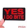 Black embroidered iron-on letter patch with red text saying YES I DO BITE