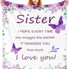 A woman smiles while holding a purple floral fleece throw blanket with the text Sister I hope every time you snuggle this bla