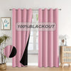 Pink blackout curtain panel hanging on a rod in a bright room.