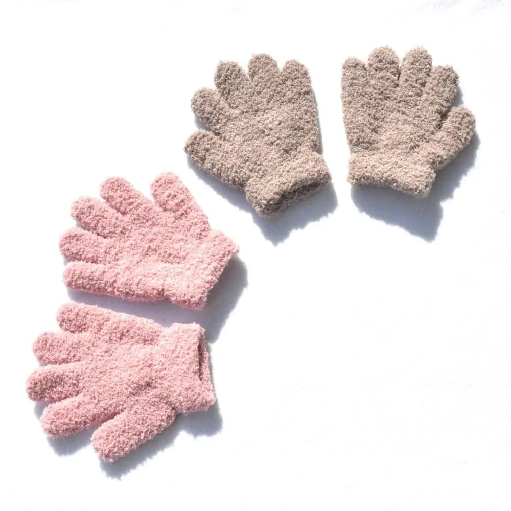 A pair of cozy plush winter gloves for kids in a light pink color, shown against a white background.