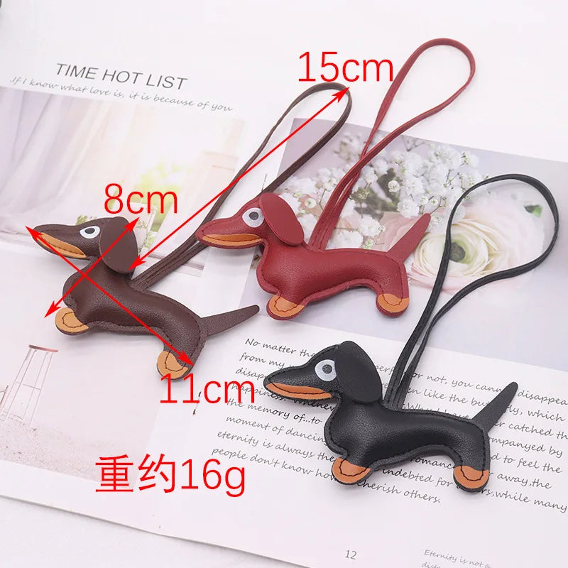 A brown dachshund shaped keychain made of PU leather with a cute puppy design shown on a white background.