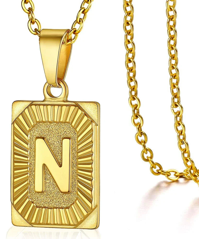 A gold-toned initial pendant necklace featuring the letter N set in a sunburst design.