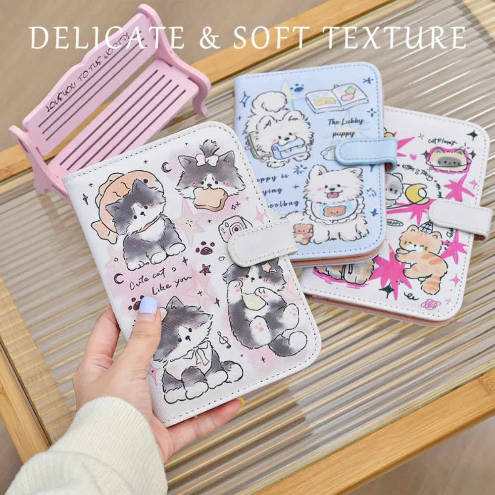 A hand holds a pink and light blue cartoon pu leather passport holder with cute animal designs on a wooden surface.