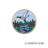 A round embroidered patch featuring a dove in flight over a landscape with reeds and water.