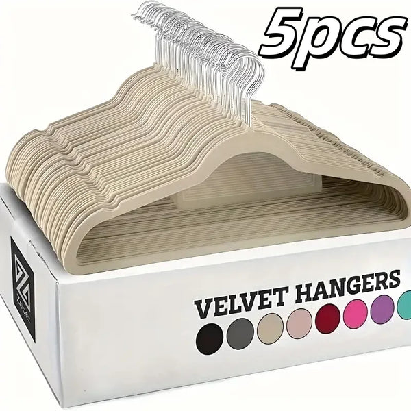A box containing five velvet hangers with a light beige color, showing the hangers inside.