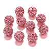 A collection of pink crystal clay round beads for DIY jewelry and craft projects arranged in a circle.