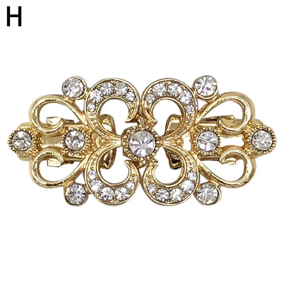 Gold vintage swirl clip featuring clear rhinestones used to fasten cardigans and shawls