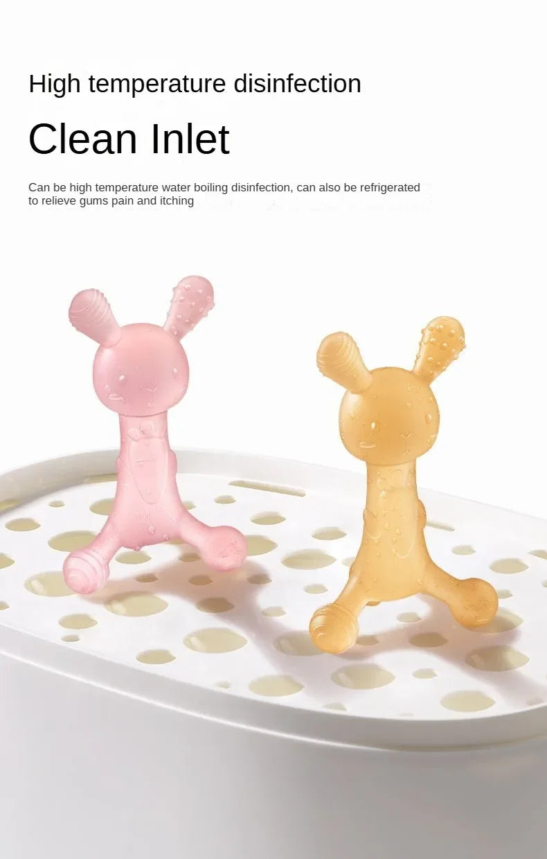 A pink silicone cartoon rabbit teether is shown floating on a white plate.