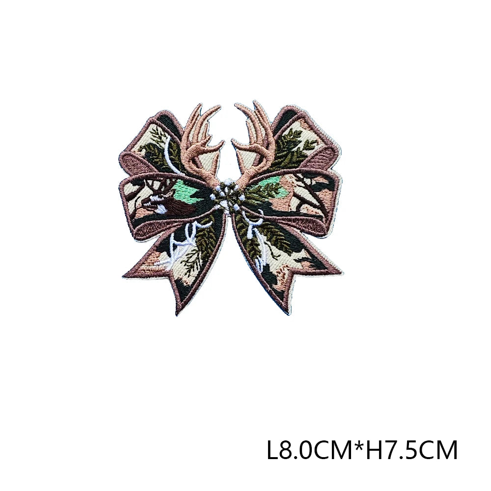 A detailed 3D embroidered hunting patch featuring green and brown foliage on a beige background.