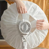 Hands are opening a white dust cover for an electric fan.