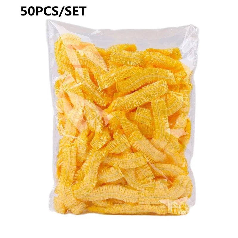 A package containing 50 pieces of yellow disposable transparent waterproof shower caps.