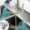 A silicone sink faucet mat with a rotatable splash guard is shown in a kitchen sink.