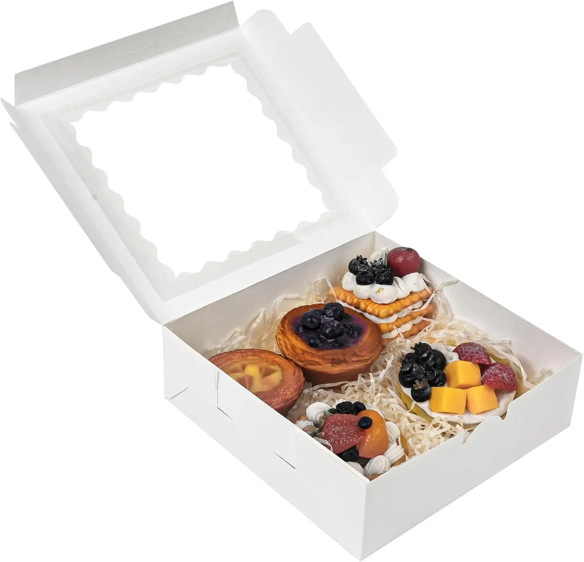 White bakery box with a clear window filled with assorted fruit and pastry treats