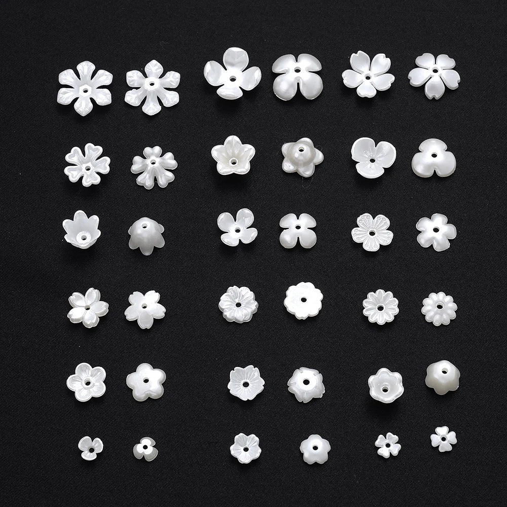 A collection of 100 acrylic pearl spacer beads in various sizes and shapes arranged on a dark surface.