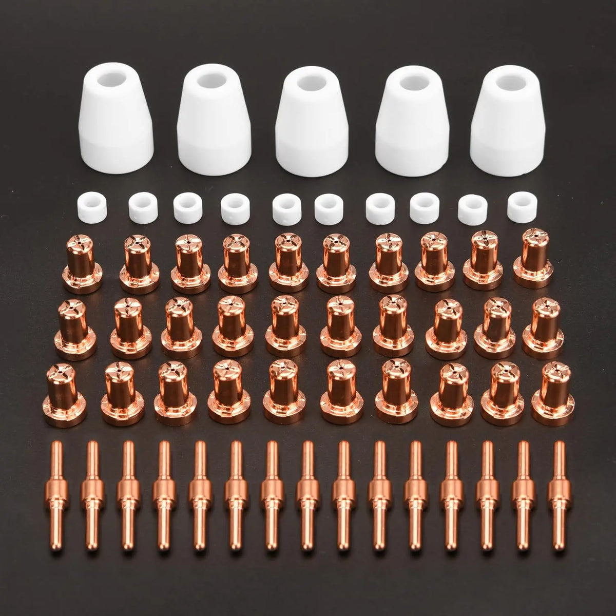 A collection of white and copper plasma cutter torch consumables, including nozzles and tips.