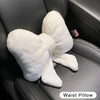 A white plush bowknot waist pillow is shown resting on a dark car seat.
