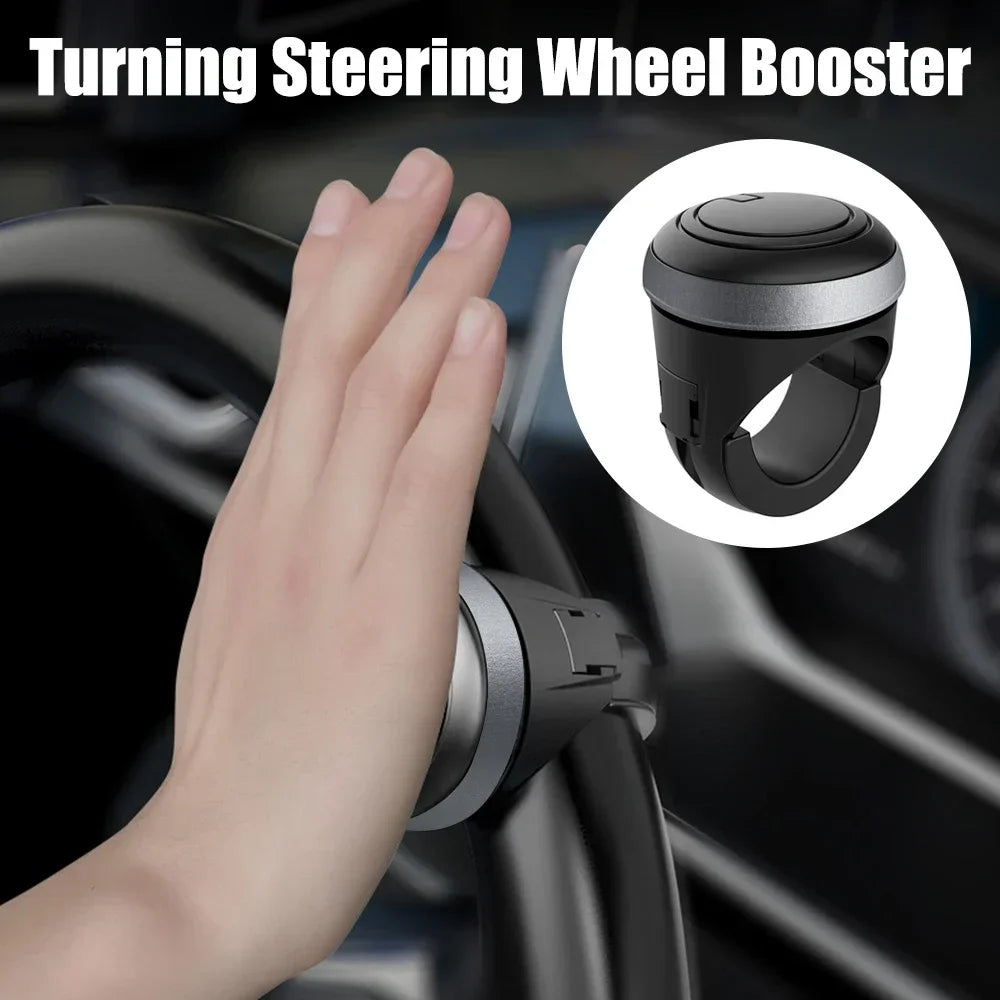 A hand is shown interacting with a steering wheel booster device, which is a rotating spinner knob for the steering wheel.
