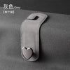 A grey car seat headrest hook with a heart-shaped dual hook for securing bags or phones.