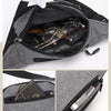 A gray canvas waist pack with multiple pockets showing various accessories inside.