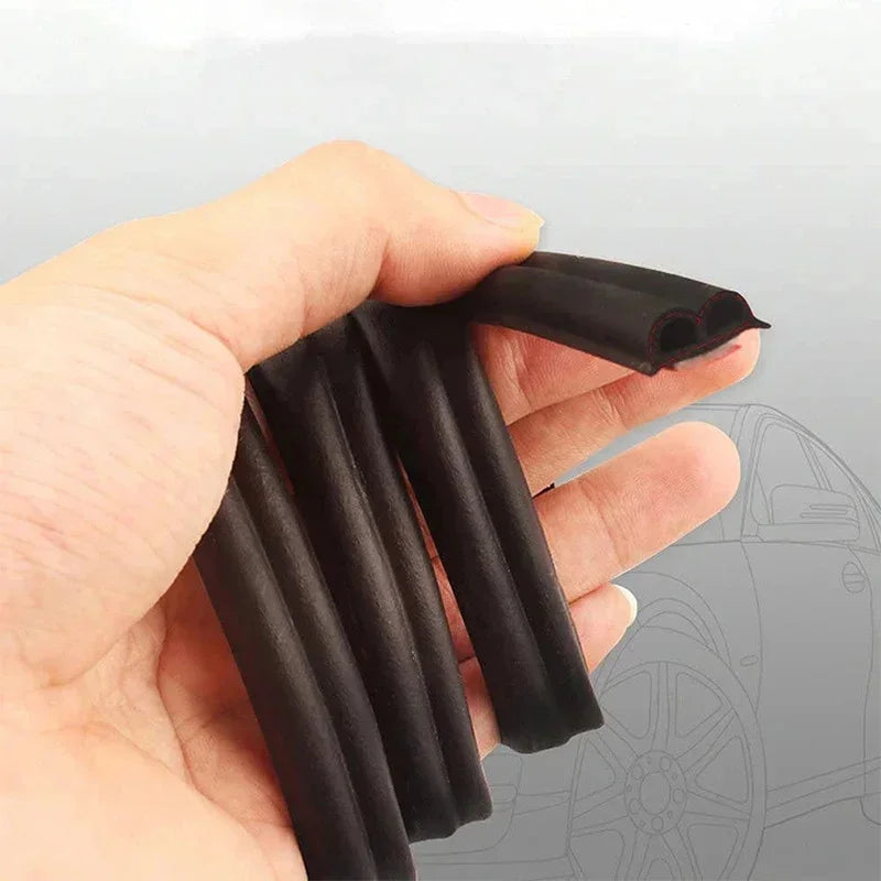 A hand holds several black flexible rubber seal strips used for car door noise reduction and weatherproofing.