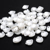 A pile of 100 white acrylic pearl spacer beads for jewelry making
