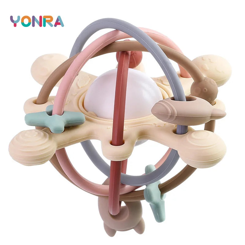 A silicone sensory rattle ball with various colored rings and a central ball for baby development.