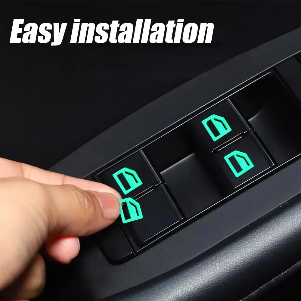 A hand is installing glow-in-the-dark car window switch stickers into a black car panel.