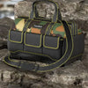 A black heavy-duty camouflage tool kit bag with a reinforced base and yellow trim, resting on dark rocks.