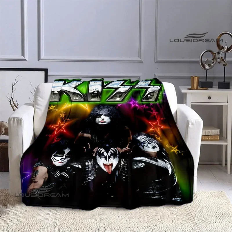 A black and green printed flannel throw blanket featuring images of the Kiss band members.