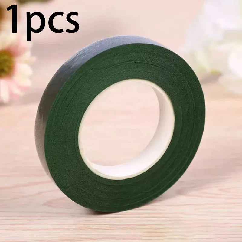 A roll of dark green chenille craft stems for DIY projects shown on a wooden surface.