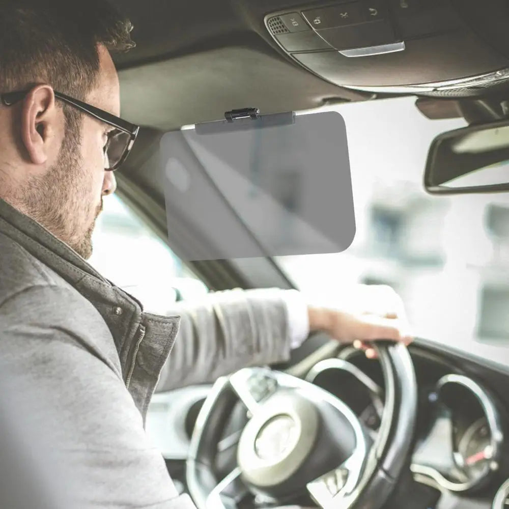 A man is adjusting an adjustable anti-glare car sun visor extender inside a vehicle.