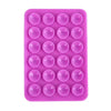 A pink silicone suction cup phone mount with multiple circular holes for hands-free viewing.