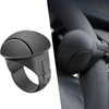 A close-up view of a black silicone steering wheel knob designed for one-hand control.